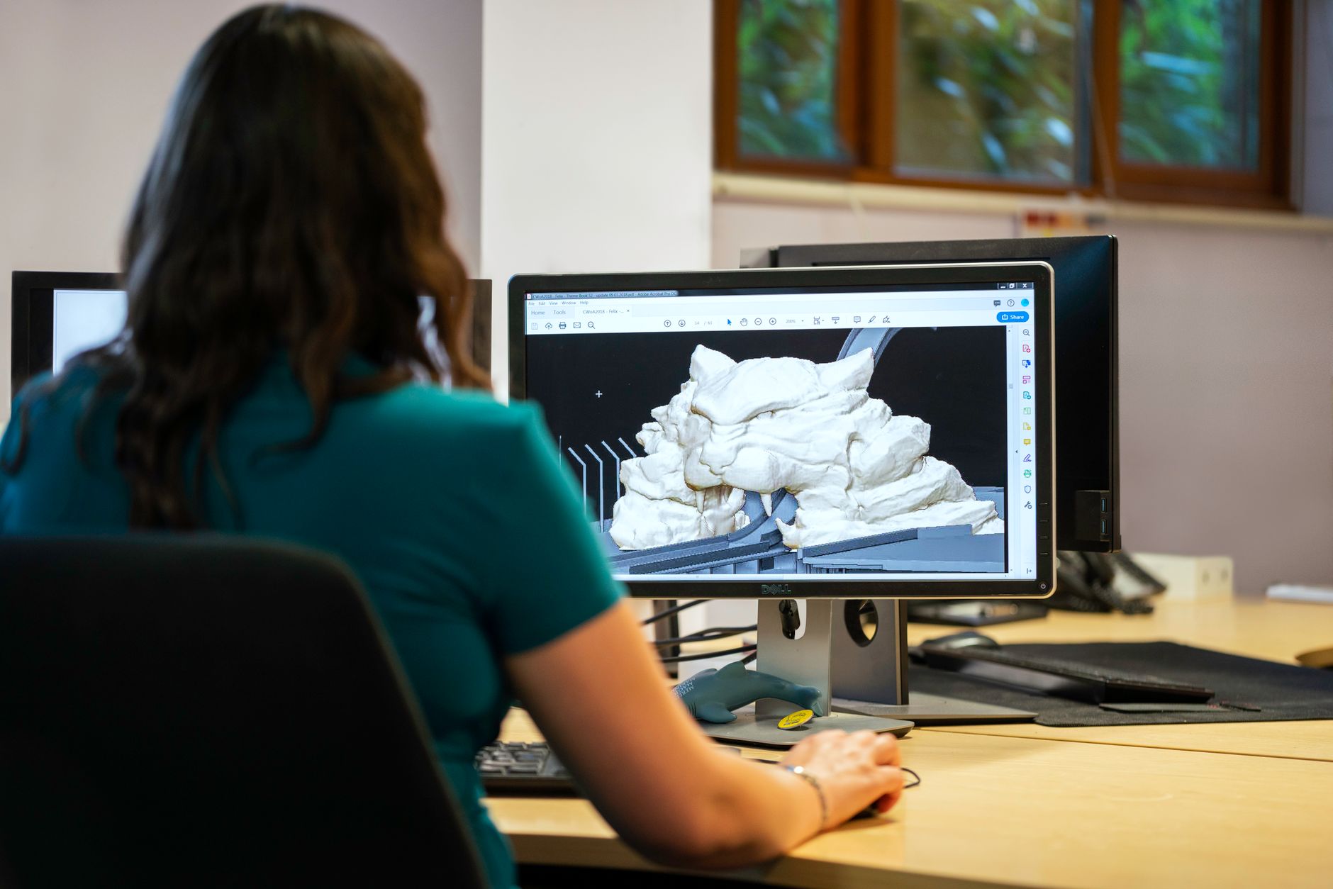 An engineer works at a computer, illustrating Deriv's engineering and AI automation remit.