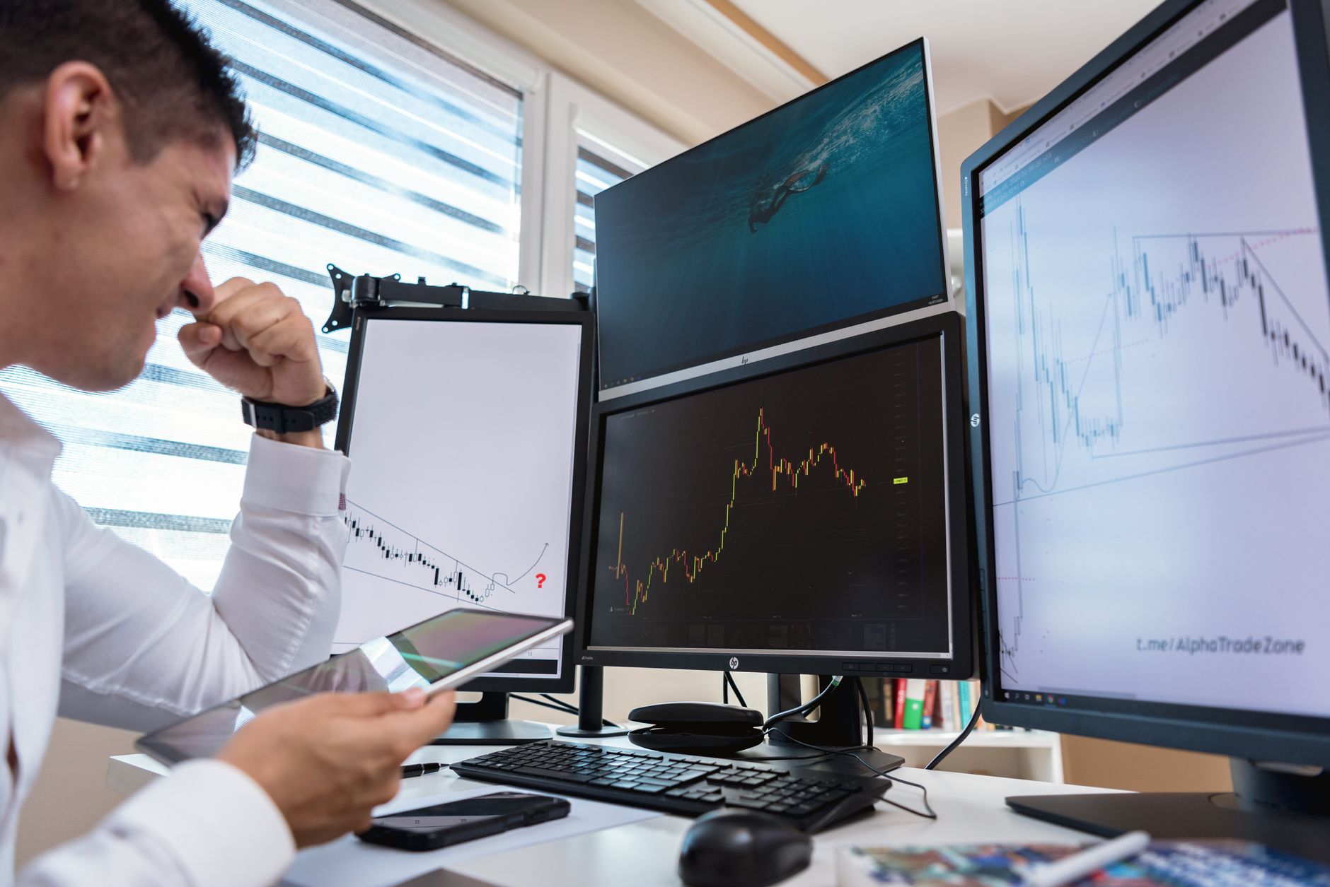 A retail trader looks at price information on a screen, illustrating the investment products covered by ESMA's European client data.