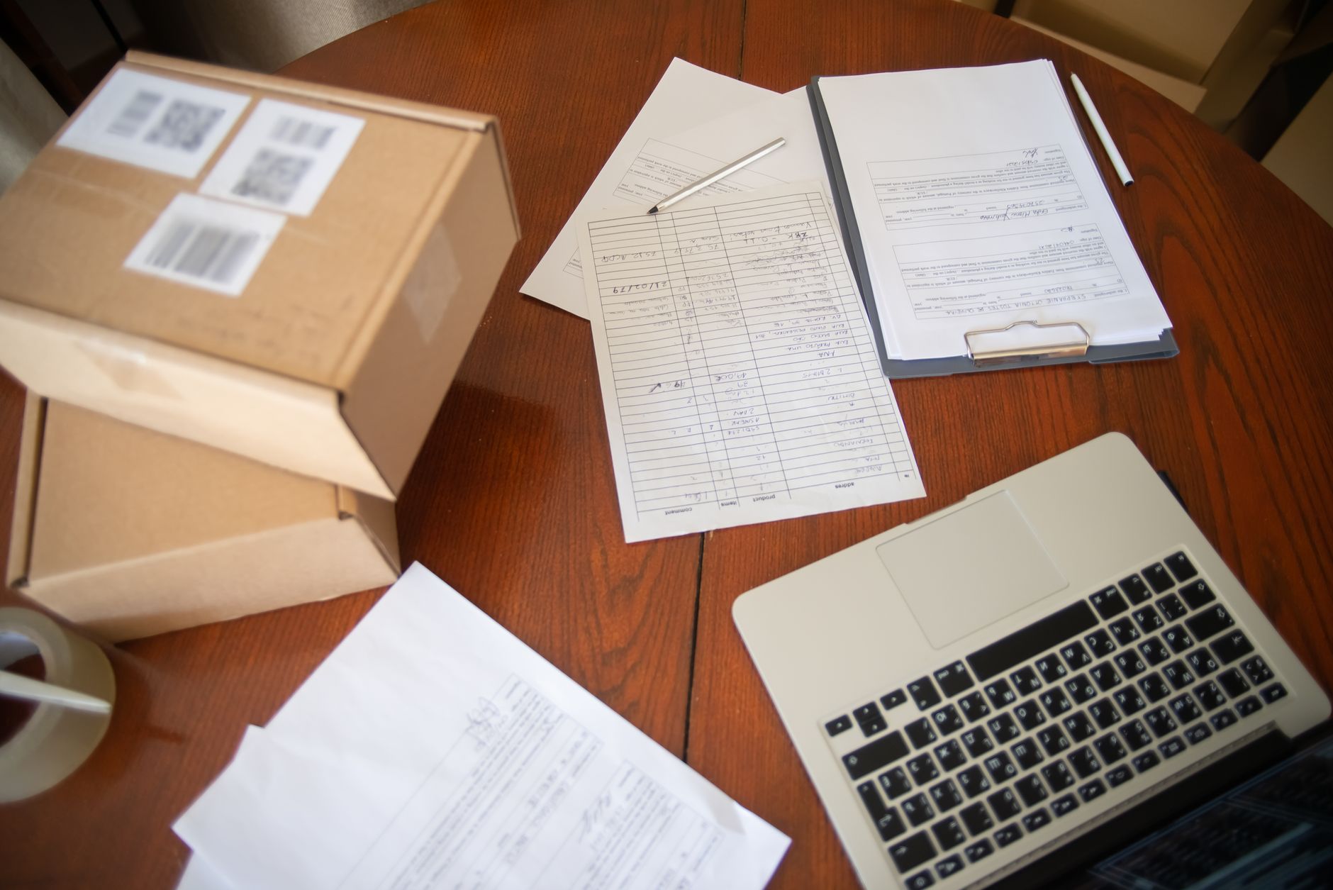 Regulatory paperwork beside a laptop, illustrating compliance work affected by proposed UK SM&CR changes.