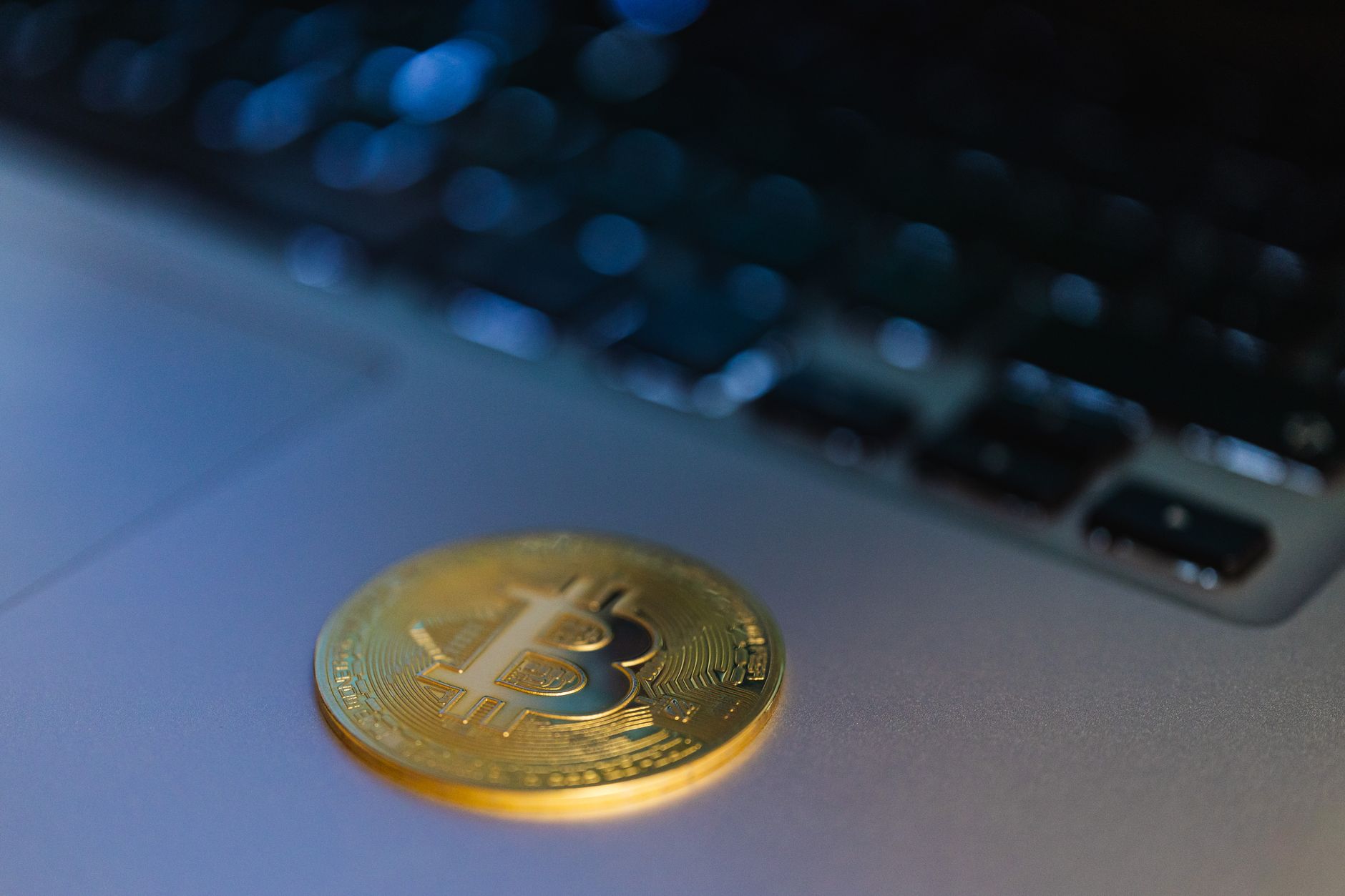 A person examines cryptocurrency transaction details on a laptop, illustrating the FCA's proposed crypto monitoring guidance.