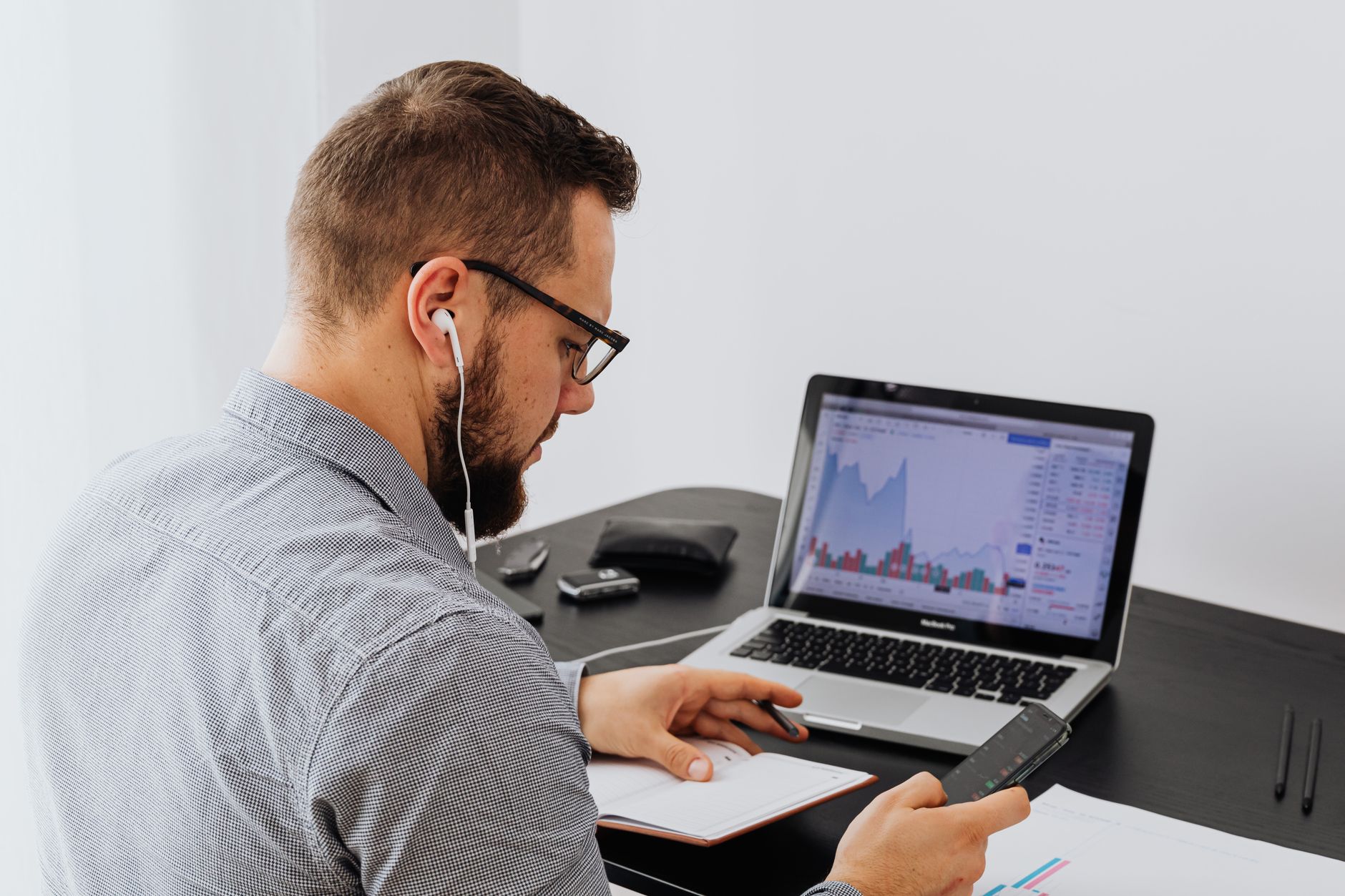 A financial analyst reviewing search results on a laptop, illustrating Obsero’s AI brand-monitoring service.