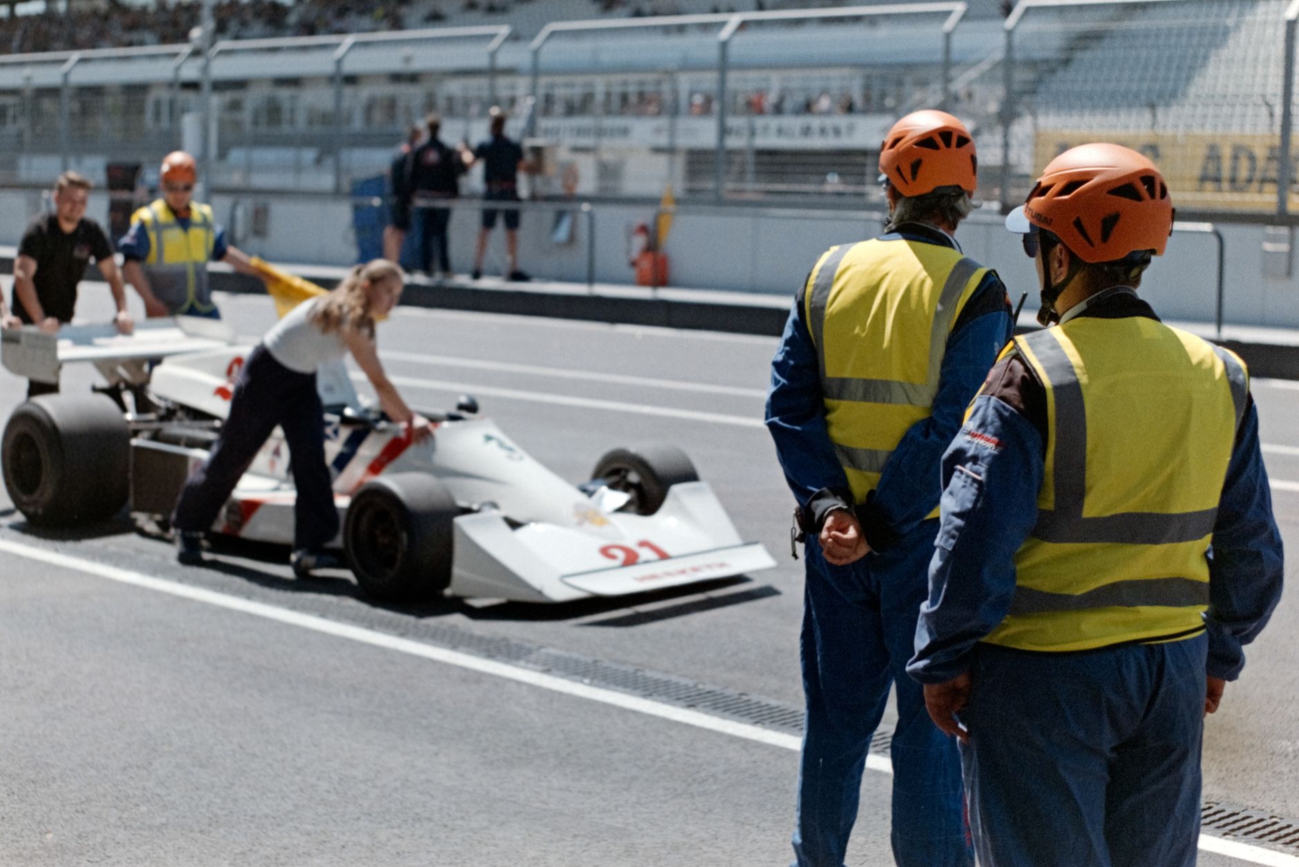 A Formula One driver wearing a race helmet in a car, illustrating Pepperstone's partnership with Fernando Alonso and Aston Martin.