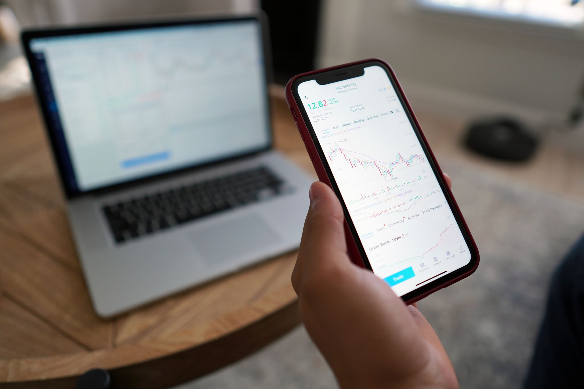 A person reviews a brokerage account on a phone, illustrating transfer offers for Webull clients.