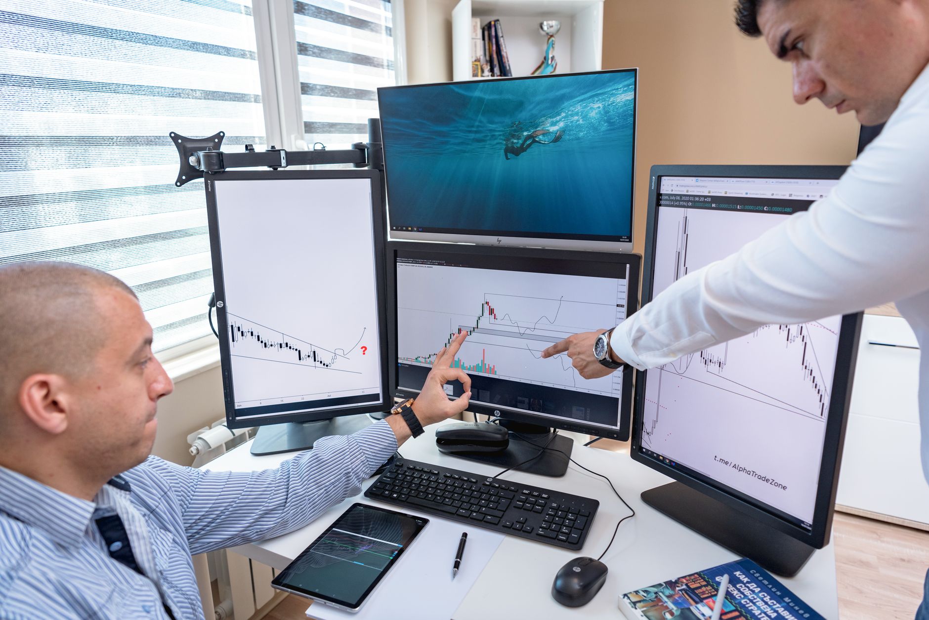 Trading professionals working at computer screens, illustrating executive hiring across brokerage, crypto and prop firms